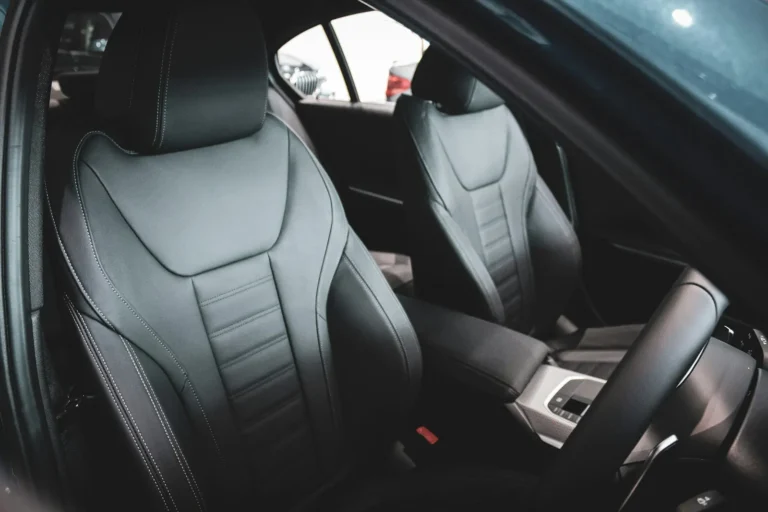 Front car seats upholstered in black leather