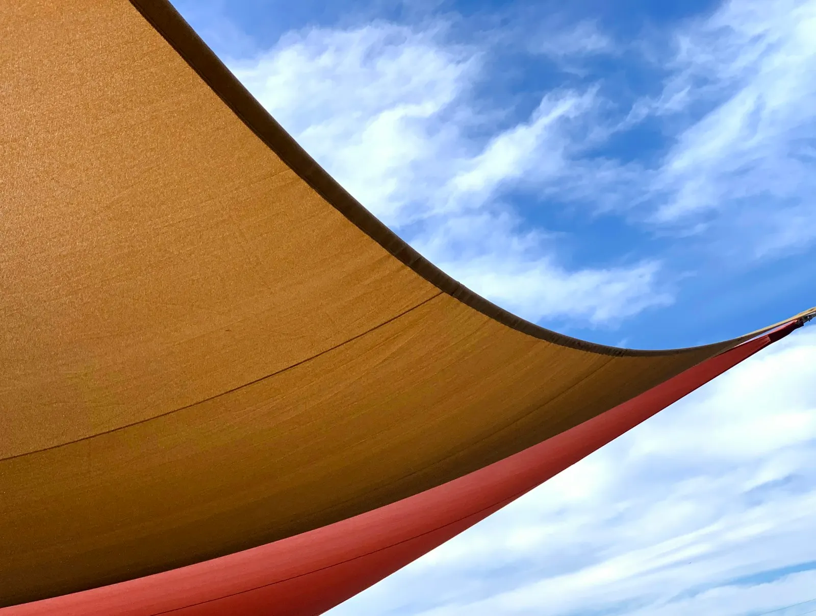 Tensioned canvas shade sail under the sky